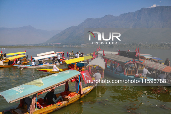 Supporters of the Jammu and Kashmir National Conference party (JKNC) participate in an election rally at Dal Lake, ahead of the second phase...