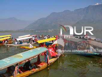 Supporters of the Jammu and Kashmir National Conference party (JKNC) participate in an election rally at Dal Lake, ahead of the second phase...