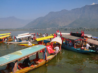 Supporters of the Jammu and Kashmir National Conference party (JKNC) participate in an election rally at Dal Lake, ahead of the second phase...