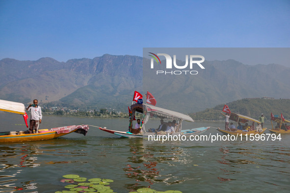 Supporters of the Jammu and Kashmir National Conference party (JKNC) participate in an election rally at Dal Lake, ahead of the second phase...