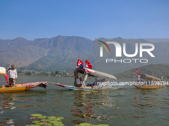 Supporters of the Jammu and Kashmir National Conference party (JKNC) participate in an election rally at Dal Lake, ahead of the second phase...