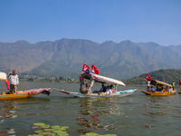 Supporters of the Jammu and Kashmir National Conference party (JKNC) participate in an election rally at Dal Lake, ahead of the second phase...