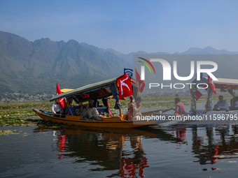 Supporters of the Jammu and Kashmir National Conference party (JKNC) participate in an election rally at Dal Lake, ahead of the second phase...