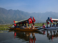 Supporters of the Jammu and Kashmir National Conference party (JKNC) participate in an election rally at Dal Lake, ahead of the second phase...