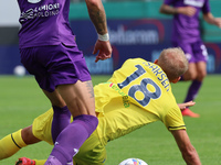 Cristiano Biraghi  of ACF Fiorentina and Gustav Isaksen of SS Lazio ,battle for the ball during the Italian Serie A football match between A...