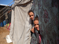 Displaced Palestinian children look out from their tent in the Mawasi area in Khan Younis, southern Gaza Strip, on September 22, 2024, amid...