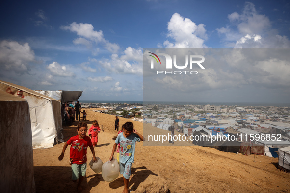 Displaced Palestinians shelter in a tent camp amid the Israel-Hamas conflict in the Al-Mawasi area in Khan Yunis in the southern Gaza Strip...