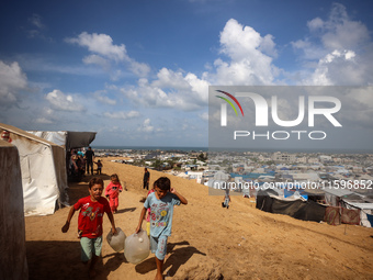 Displaced Palestinians shelter in a tent camp amid the Israel-Hamas conflict in the Al-Mawasi area in Khan Yunis in the southern Gaza Strip...