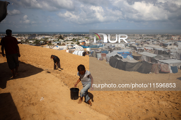 Displaced Palestinians shelter in a tent camp amid the Israel-Hamas conflict in the Al-Mawasi area in Khan Yunis in the southern Gaza Strip...