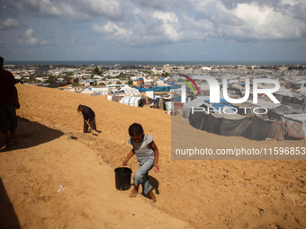 Displaced Palestinians shelter in a tent camp amid the Israel-Hamas conflict in the Al-Mawasi area in Khan Yunis in the southern Gaza Strip...