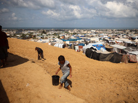 Displaced Palestinians shelter in a tent camp amid the Israel-Hamas conflict in the Al-Mawasi area in Khan Yunis in the southern Gaza Strip...