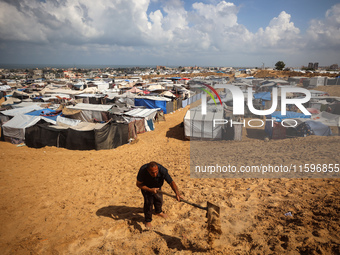 Displaced Palestinians shelter in a tent camp amid the Israel-Hamas conflict in the Al-Mawasi area in Khan Yunis in the southern Gaza Strip...