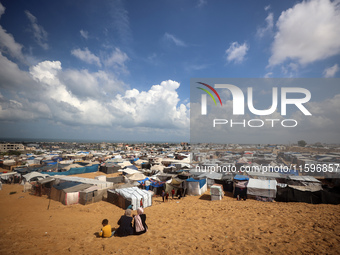 Displaced Palestinians shelter in a tent camp amid the Israel-Hamas conflict in the Al-Mawasi area in Khan Yunis in the southern Gaza Strip...