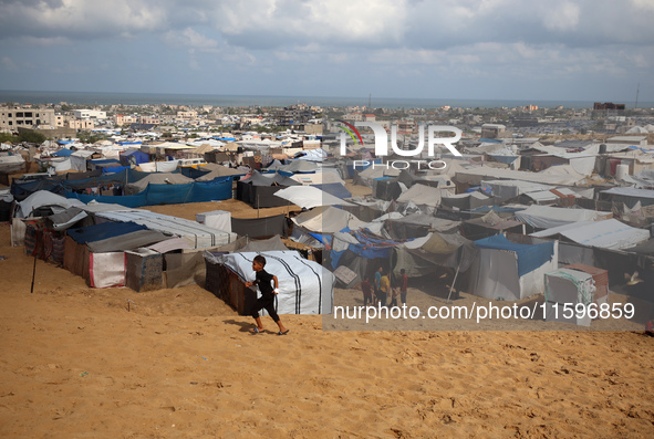 Displaced Palestinians shelter in a tent camp amid the Israel-Hamas conflict in the Al-Mawasi area in Khan Yunis in the southern Gaza Strip...