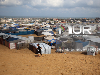 Displaced Palestinians shelter in a tent camp amid the Israel-Hamas conflict in the Al-Mawasi area in Khan Yunis in the southern Gaza Strip...