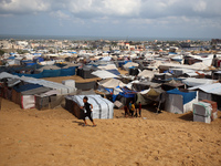 Displaced Palestinians shelter in a tent camp amid the Israel-Hamas conflict in the Al-Mawasi area in Khan Yunis in the southern Gaza Strip...