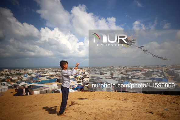 Displaced Palestinians shelter in a tent camp amid the Israel-Hamas conflict in the Al-Mawasi area in Khan Yunis in the southern Gaza Strip...