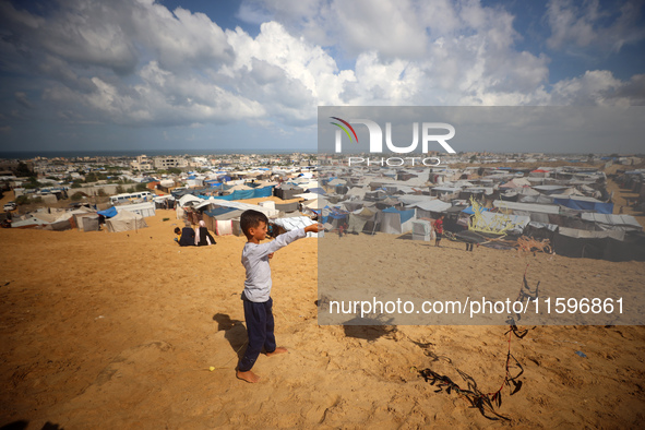 Displaced Palestinians shelter in a tent camp amid the Israel-Hamas conflict in the Al-Mawasi area in Khan Yunis in the southern Gaza Strip...