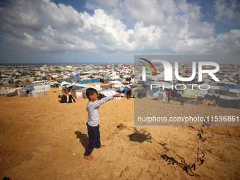 Displaced Palestinians shelter in a tent camp amid the Israel-Hamas conflict in the Al-Mawasi area in Khan Yunis in the southern Gaza Strip...