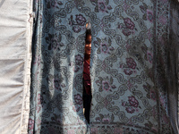 A Palestinian boy looks out from his tent in the Al-Mawasi area in Khan Yunis in the southern Gaza Strip on September 22, 2024, amid the ong...