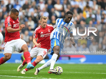 Danny Welbeck of Brighton is under pressure from James Ward-Prowse and Murillo of Nottingham Forest during the Premier League match between...