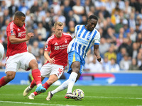 Danny Welbeck of Brighton is under pressure from James Ward-Prowse and Murillo of Nottingham Forest during the Premier League match between...