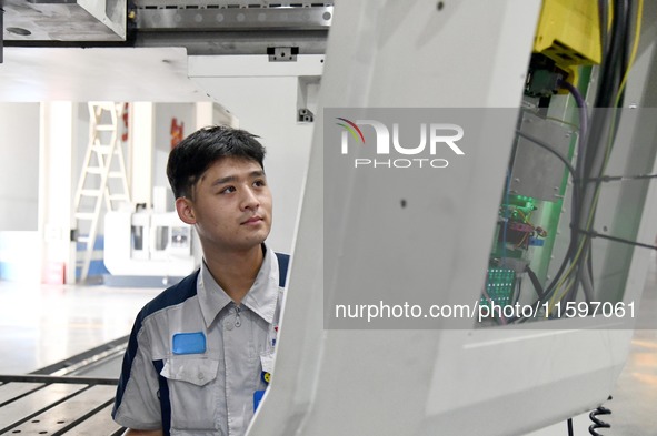 An employee debuts a CNC machine tool at an intelligent equipment company in Zaozhuang, China, on September 21, 2024. 