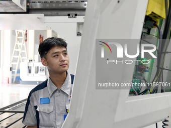 An employee debuts a CNC machine tool at an intelligent equipment company in Zaozhuang, China, on September 21, 2024. (