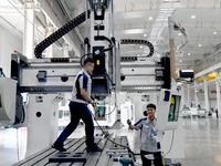 An employee debuts a CNC machine tool at an intelligent equipment company in Zaozhuang, China, on September 21, 2024. (