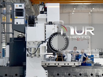 An employee debuts a CNC machine tool at an intelligent equipment company in Zaozhuang, China, on September 21, 2024. (