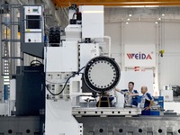 An employee debuts a CNC machine tool at an intelligent equipment company in Zaozhuang, China, on September 21, 2024. (