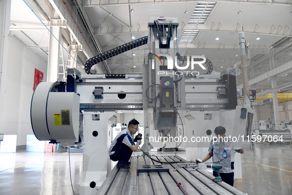 An employee debuts a CNC machine tool at an intelligent equipment company in Zaozhuang, China, on September 21, 2024. 