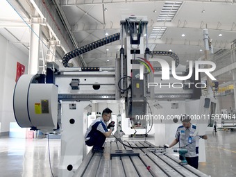 An employee debuts a CNC machine tool at an intelligent equipment company in Zaozhuang, China, on September 21, 2024. (