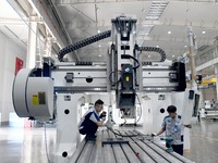 An employee debuts a CNC machine tool at an intelligent equipment company in Zaozhuang, China, on September 21, 2024. (