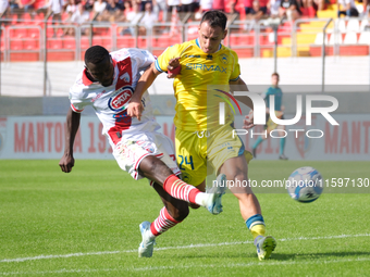 Davis Mensah of Mantova 1911 contrasts with Lorenzo Carissoni of AS Cittadella 1973 during the Italian Serie B soccer championship match bet...