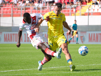 Davis Mensah of Mantova 1911 contrasts with Lorenzo Carissoni of AS Cittadella 1973 during the Italian Serie B soccer championship match bet...