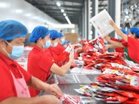 Workers inspect food in Tengzhou, China, on September 21, 2024. (