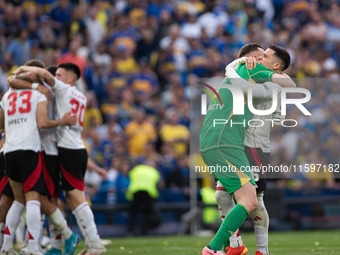 River Plate players celebrate after their team defeats Boca Juniors in an Argentine soccer league match at La Bombonera stadium in Buenos Ai...