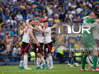 River Plate players celebrate after their team defeats Boca Juniors in an Argentine soccer league match at La Bombonera stadium in Buenos Ai...