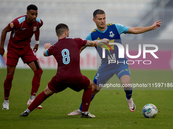 Jean Borg (R) of Sliema Wanderers competes for the ball with Zachary Scerri (C) of Gzira United during the Malta 360 Sports Premier League s...