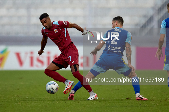 Thaylor Aldama of Gzira United moves with the ball away from the close challenge of Jean Borg of Sliema Wanderers during the Malta 360 Sport...