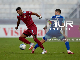 Thaylor Aldama of Gzira United moves with the ball away from the close challenge of Jean Borg of Sliema Wanderers during the Malta 360 Sport...