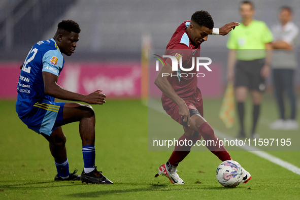 Thaylor Aldama of Gzira United is closely followed by Simon Zibo of Sliema Wanderers during the Malta 360 Sports Premier League soccer match...