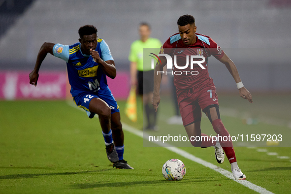 Thaylor Aldama of Gzira United is closely followed by Simon Zibo of Sliema Wanderers during the Malta 360 Sports Premier League soccer match...