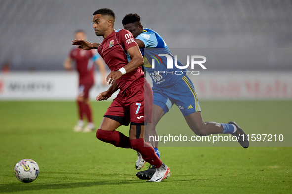 Thaylor Aldama of Gzira United is closely followed by Simon Zibo of Sliema Wanderers during the Malta 360 Sports Premier League soccer match...