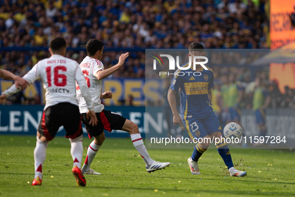 Lautaro Blanco of Boca Juniors and Ignacio Fernandez of River Plate battle for the ball during an Argentine soccer league match at La Bombon...