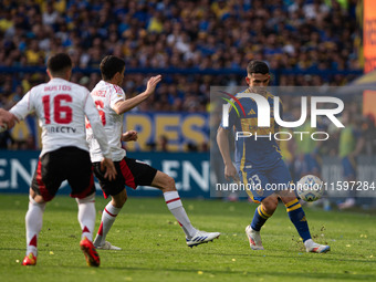 Lautaro Blanco of Boca Juniors and Ignacio Fernandez of River Plate battle for the ball during an Argentine soccer league match at La Bombon...