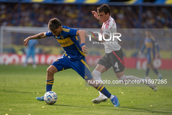 Exequiel Zeballos of Boca Juniors and Nicolas Fonseca of River Plate battle for the ball during an Argentine soccer league match at La Bombo...