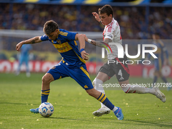 Exequiel Zeballos of Boca Juniors and Nicolas Fonseca of River Plate battle for the ball during an Argentine soccer league match at La Bombo...