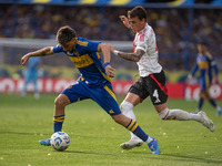 Exequiel Zeballos of Boca Juniors and Nicolas Fonseca of River Plate battle for the ball during an Argentine soccer league match at La Bombo...